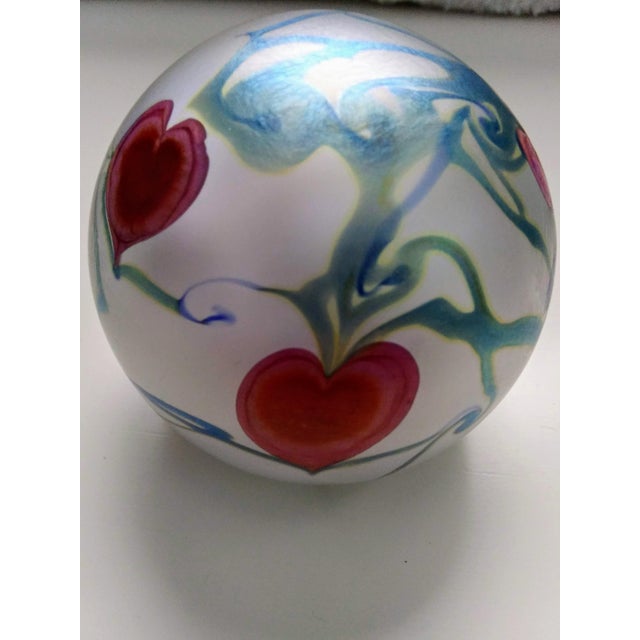 This gorgeous pearlescent 3.5" paper weight created in 1985 by famed glass maker Robert Vandermark. The piece shows red...
