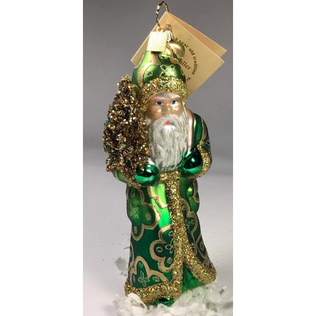 Ino Schaller has been producing Paper Mache Santa Candy Containers since 1869. This beautiful glass Santa Ornament was...