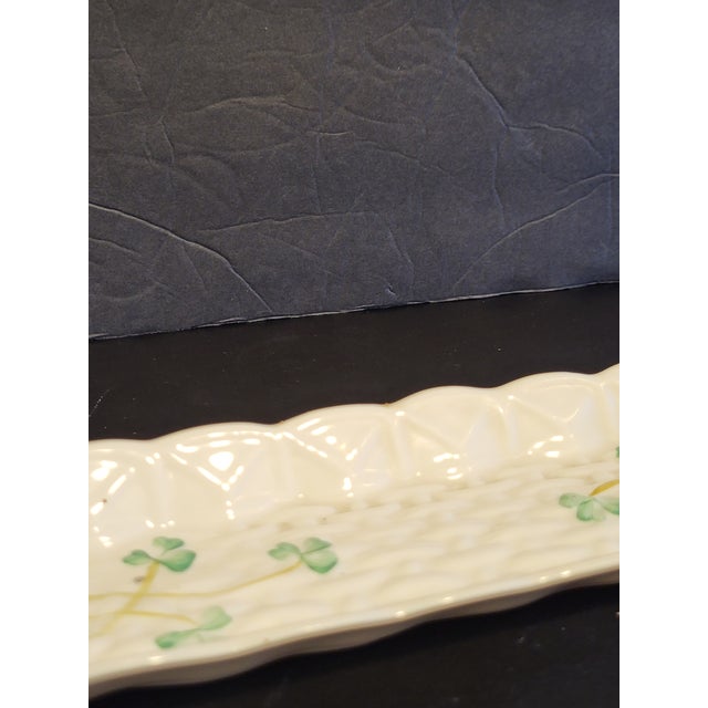 Belleek vintage curved shell dish for mints/candy. Creamy white Parian porcelain with pale green clover accents. Made in...
