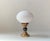 A stylish art deco revival table light. It features a stepped bronze base, black orb center sphere and a horizontally...