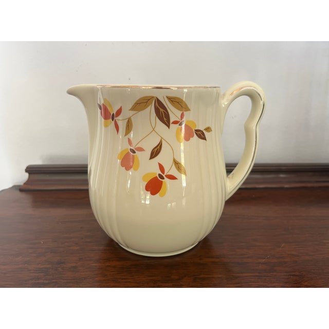 Charming vintage Hall China pitcher or large creamer in the classic Jewel Tea Autumn Leaf pattern. The vertically ribbed...
