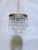Italian layered chandelier with decorative brass rim, octagon beads and hand blown teardrops. It has 3 layers of crystals...