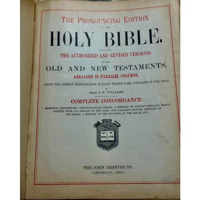 This is an ornate, late 19th century family Bible, characterized by its heavy, embossed leather cover and decorative gold-...