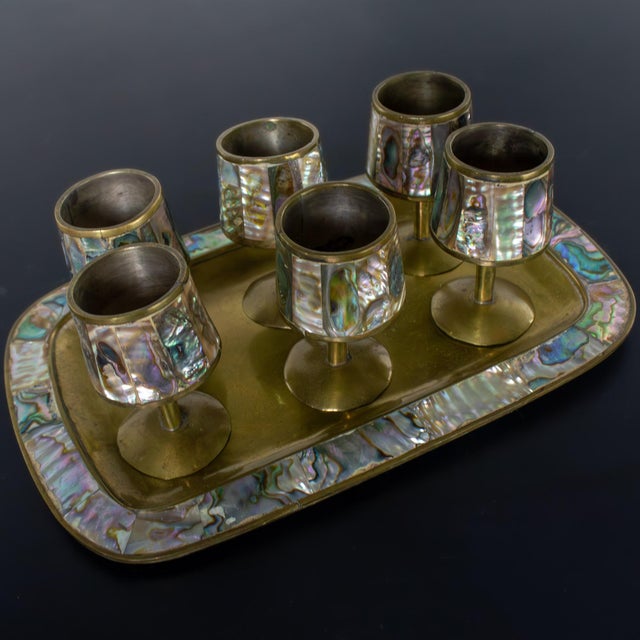 Marvelous vintage MCM (a.k.a.) Mid-Century Modern set of 6 cordial stemmed shots and matching tray composed of brass and...