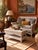 An early 20th century wicker coffee table with a woven rectangular top, braided borders, curved apron and full lower...