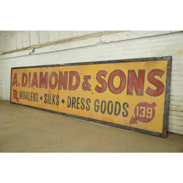Reclaimed movie set sign made of aluminum in yellow-orange, red, and black colors. The sign reads "A. Diamond & Sons, 139,...