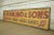 Reclaimed movie set sign made of aluminum in yellow-orange, red, and black colors. The sign reads "A. Diamond & Sons, 139,...