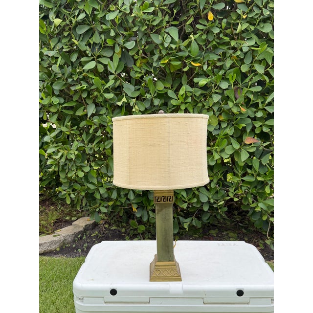 Vintage architectural table lamp featuring a tall square column with a geometric base and Greek key detail. The aged...