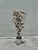 Whimsical sculptural tree featuring cascading clusters of hand-formed metal disc leaves in varied patinated tones, mounted...