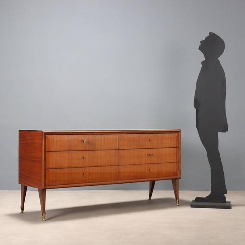 A six-drawer dresser featuring an exotic wood and teak veneer and a back-treated glass top. Some keys are missing. This...