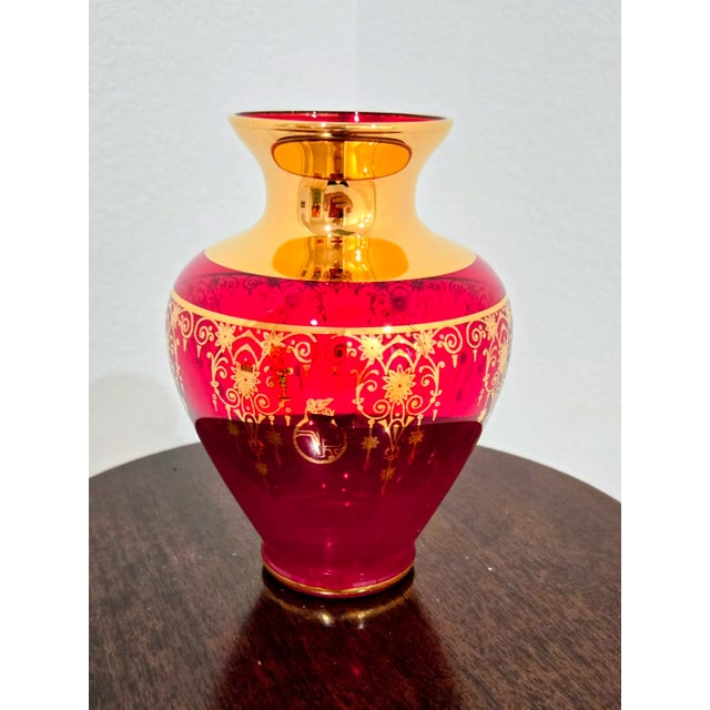 This striking ruby red glass bud vase embodies the elegant fusion of Venetian and Bohemian glass traditions. The vase...