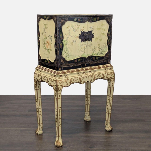 This Chinoiserie hand painted jewelry chest features detailed floral and bird designs on both the doors and drawers and...