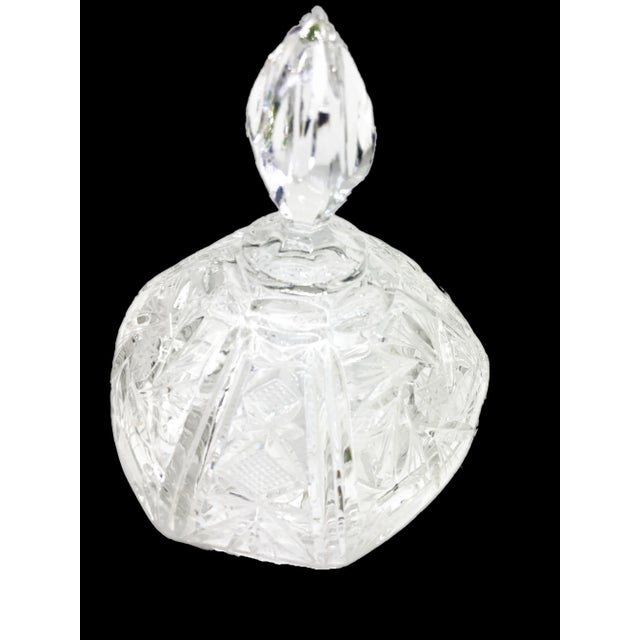 The Vintage Cut Crystal 3 Leg Swirled Star Pinwheel Design Covered Candy Dish is a timeless embodiment of elegance and...