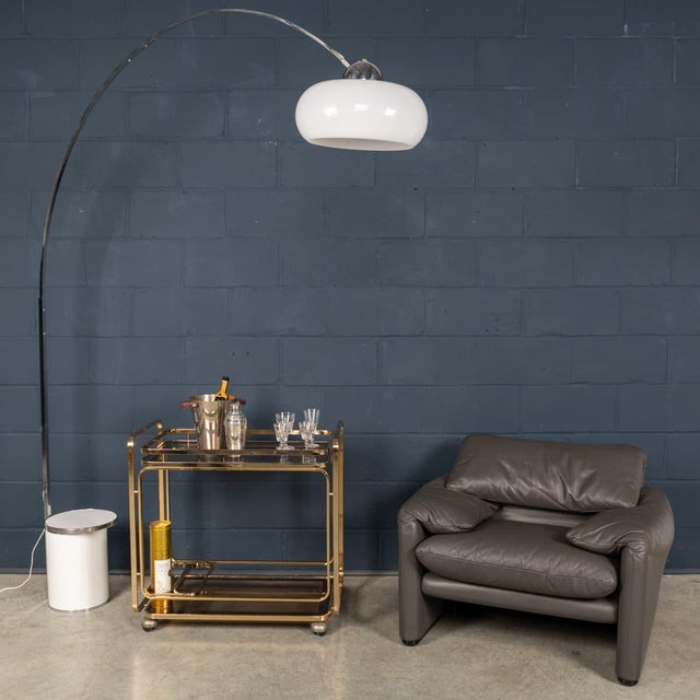 A striking Italian arc floor lamp dating from the 1970s, combining minimalist Space Age design with elegant proportions....