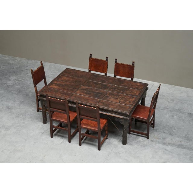 Set of antique rajasthan courtyard door dining table with 6 spanish oak and leather chairs this is a large antique indian...