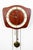 Teak wall clock featuring a unique curved shape.. Comes with weights as well as original pendulum and offers a chime. May...