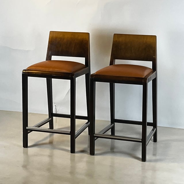 Pair of chic post-modern counter height stools Cognac leather seats. Chrome footrests. Comfortable and sturdy. Great for a...