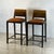 Pair of chic post-modern counter height stools Cognac leather seats. Chrome footrests. Comfortable and sturdy. Great for a...