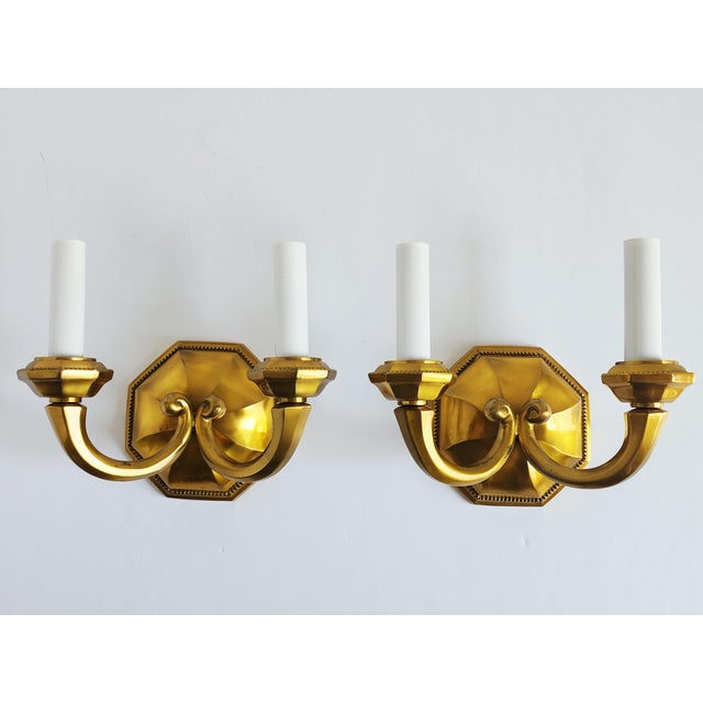 Early 20th century Georgian style lacquered cast brass wall sconces with twin-arm. Featuring octagonal beveled edges back...