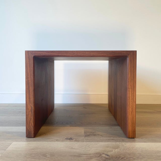 Solid walnut handmade side table features exposed end grain running along the top sides, creating a subtle contrast with...