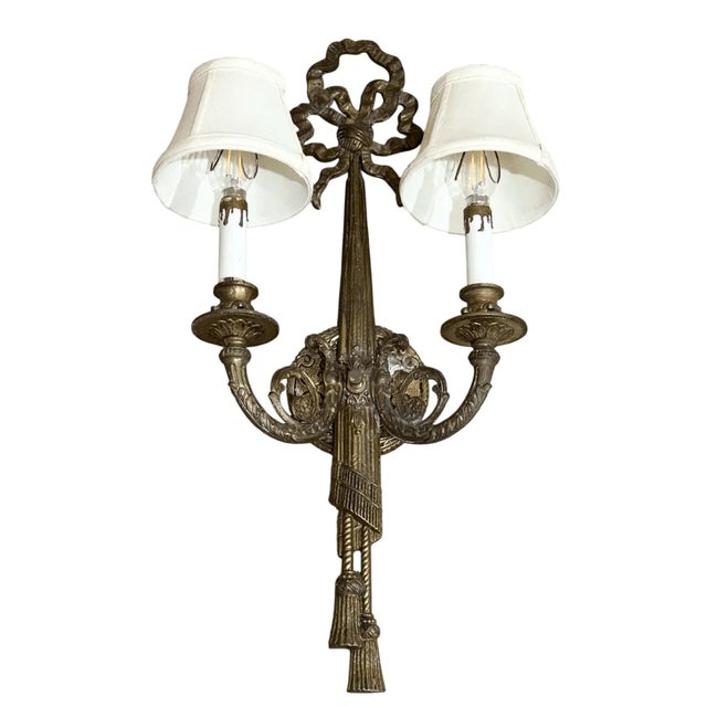 23” tall 10” across Good condition Crafted from richly detailed gilt brass, this two-light fixture is adorned with...