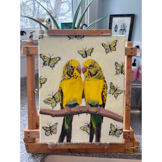 Original contemporary painting featuring a pair of yellow parakeets perched together, surrounded by softly rendered...