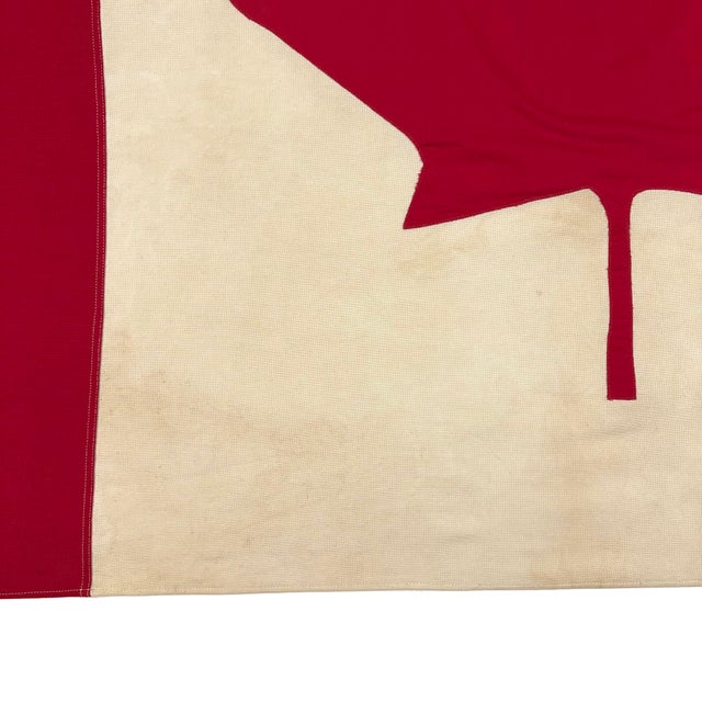 This vintage Canadian flag is made from a cotton cloth, with fully sewn design visible on both sides. Please note staining...