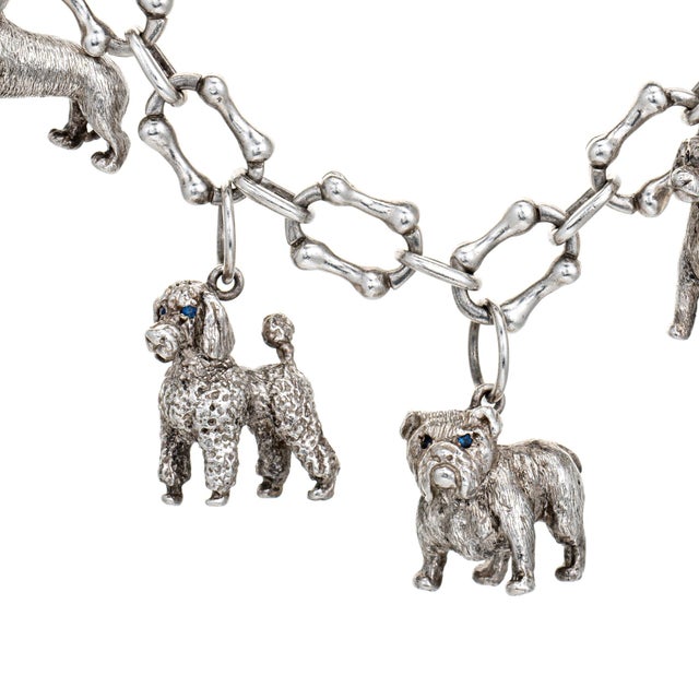 Stylish vintage Tiffany & Co dog themed charm bracelet crafted in sterling silver (circa 1980s). A hard to find and...