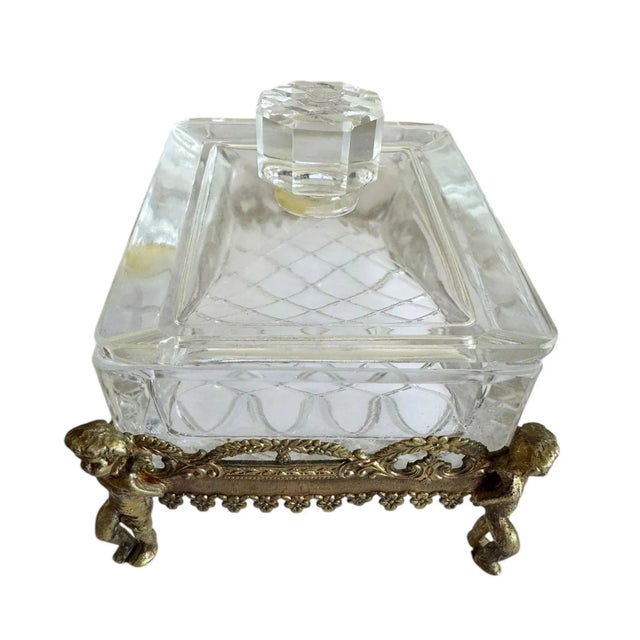 An exquisite French crystal and bronze dresser box featuring a detached lid topped with a large, cut crystal finial. The...