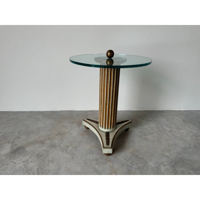 A gorgeous Vintage Hollywood Regency carved wood column pedestal base with brass ball feet and glass top side table....