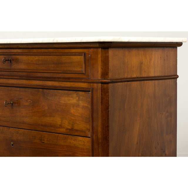 Sourced in Provence, France, this mid-19th century Louis Philippe commode is crafted in walnut veneer and topped with its...