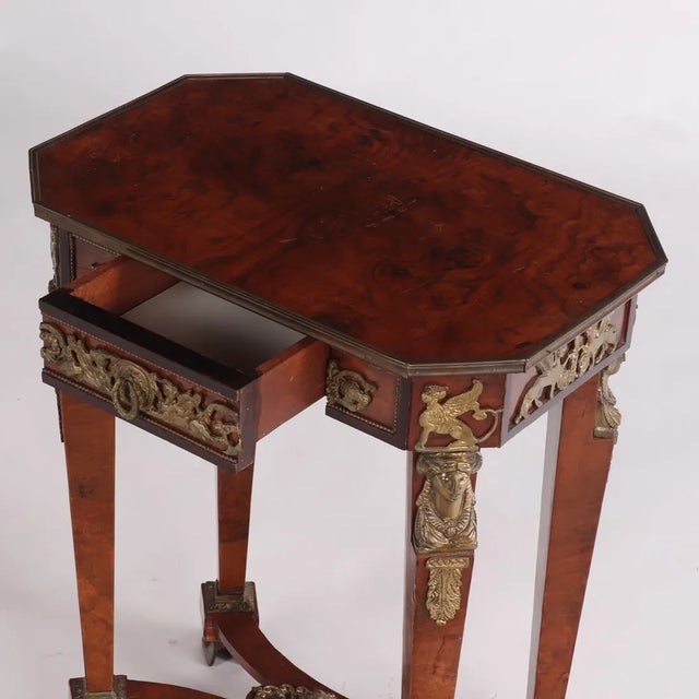 Likely from the early 1900s, or perhaps earlier, this stunning side table has extraordinary bronze figural detail and...