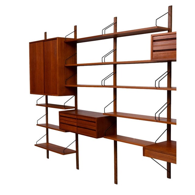 Look at this stunning hanging Wall System, warm Teak Color . Iconic design by Poul Cadovius . Signed . 4 Cabinets, one...