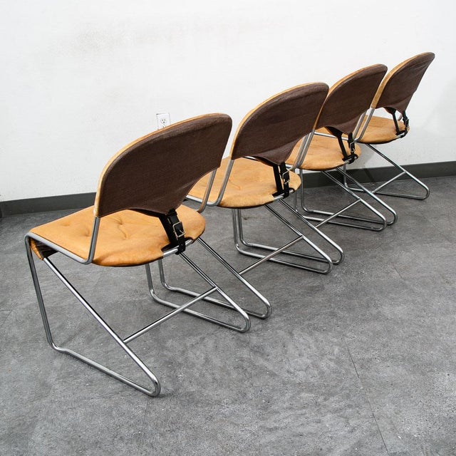 Set of 5 tan leather dining room chairs with metal frames by Sam Larsson for Dux. The photos only show 4 chairs but there...
