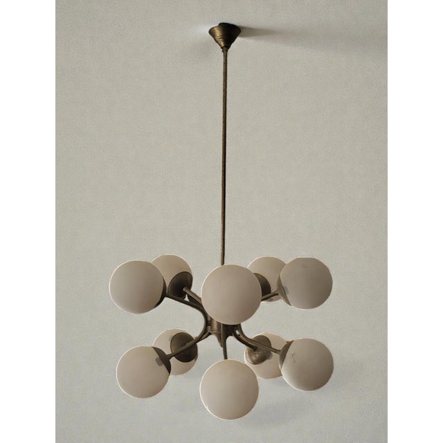 Sputnik pendant light, 1950s. Metal construction with an opaline glass shade. Height 87 cm Diameter 48 cm Some rust spots...