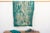A rare regional variation of West African indigo, featuring saturated teal-green hues and hand-stitched details. This...