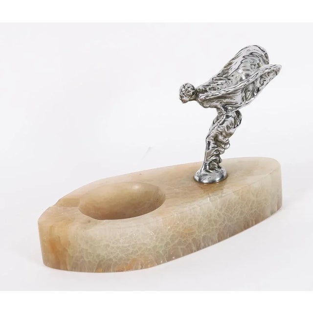 A beautiful antique rolls royce silver plated car mascot on an alabaster base, the spirit of ecstasy and dating from...