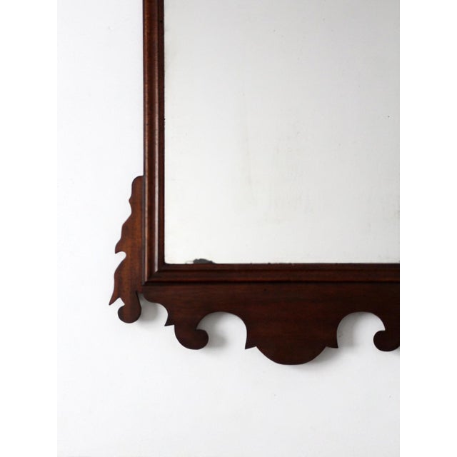 An antique 19th Century American Federal Style Mirror with Carved Eagle Crest and Scrollwork Frame. This handcrafted wall...