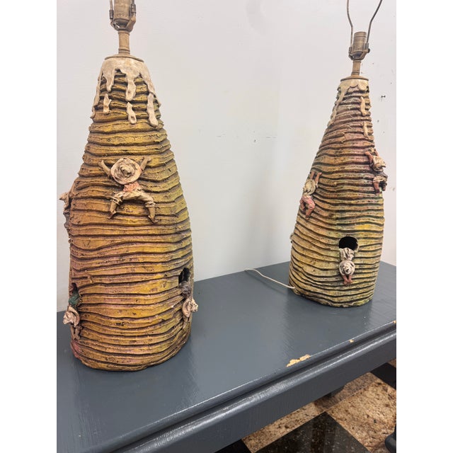 An exceptional pair of monumental handcrafted studio pottery lamps, signed and dated 1992. These highly sculptural ceramic...