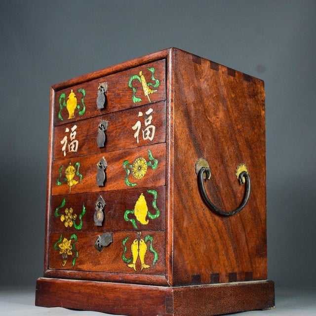 This charming vintage tabletop cabinet is crafted from Chinese rosewood (hua li mu) and features five graduated drawers,...