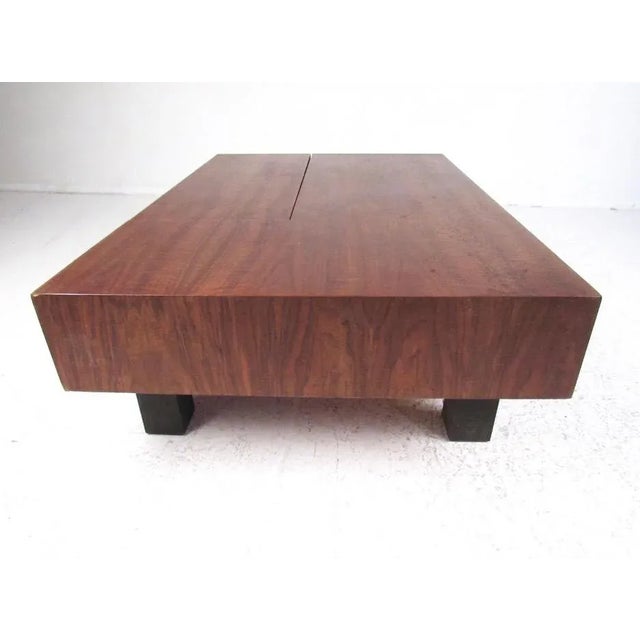 This impressive vintage modern coffee table by Drexel furniture features beautiful walnut finish, ebonized hardwood sides,...