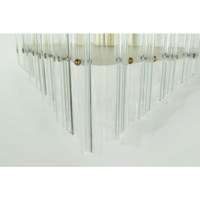 Elevate your living space with these Very Large Mid-Century Lucite Sconces from circa20c, standing an impressive 30" tall...