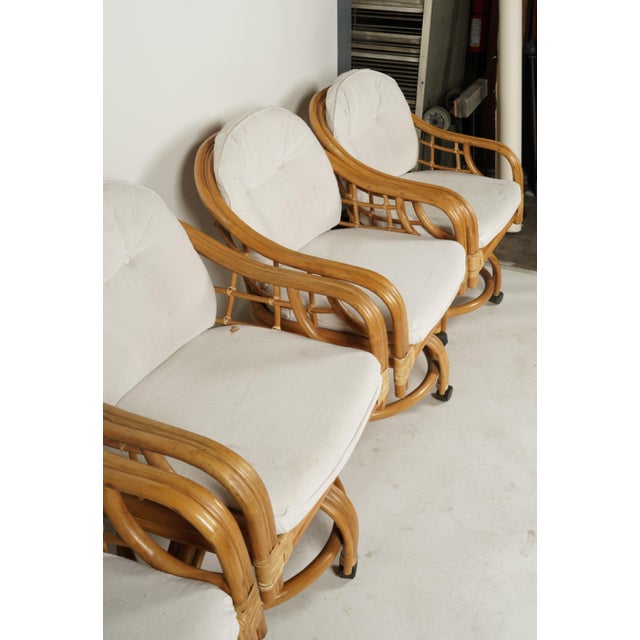 Set of Four Vintage Coastal Rattan Swivel Lounge Chairs on Casters With Original Cushions For Sale - Image 4 of 7