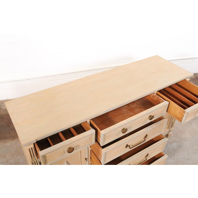 A French painted wood buffet or sideboard cabinet from the mid-20th century. This mid-century console cabinet from France...
