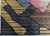This striking modern Sauron rug features a bold, abstract composition defined by layered geometric forms and dynamic...