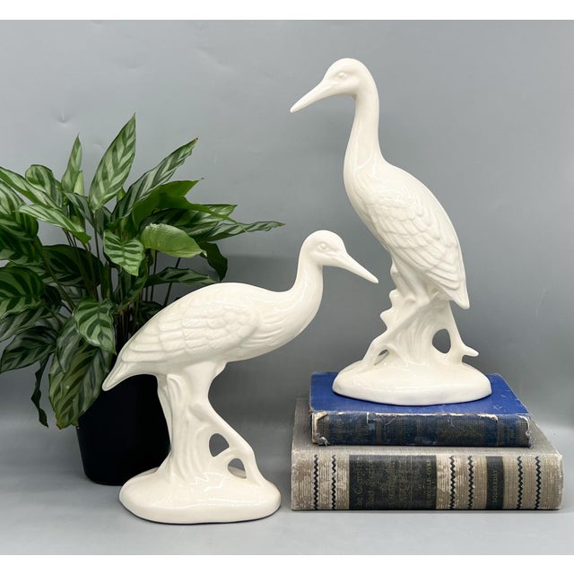 Chic and sculptural pair of tall cream white ceramic cranes, beautifully hand-formed and signed “Essie B 1984” on the...