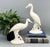 Chic and sculptural pair of tall cream white ceramic cranes, beautifully hand-formed and signed “Essie B 1984” on the...