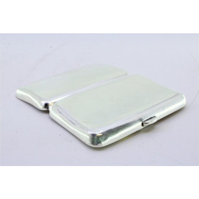 Curved Silver Cigarette Case with Spring-Loaded Hinged Lid, in Very Good conditions. Designed 1890 to 1919 This piece has...