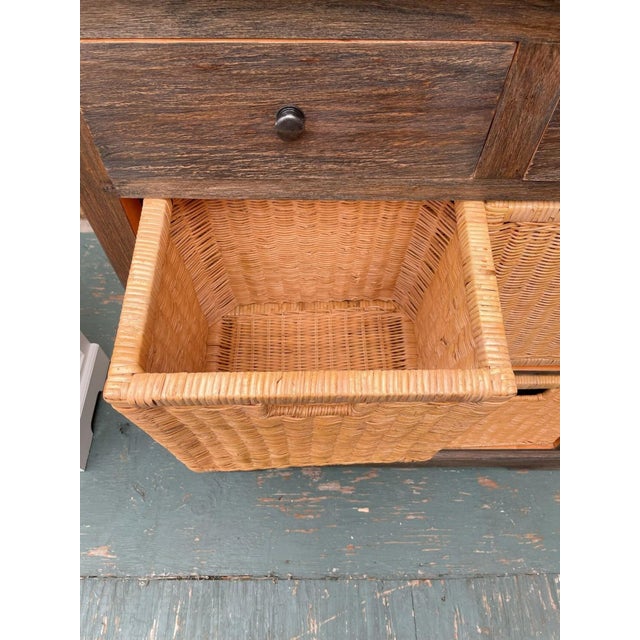 This Coastal Living cabinet offers tall and narrow storage with a rustic finish, crafted from solid wood. It features two...