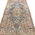 An intriguing antique rug with a distinctive elongated pink medallion set against a blue field. The composition is...